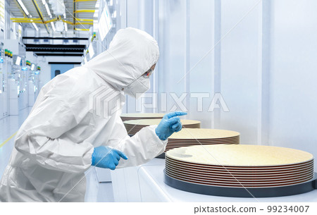 Worker or engineer wears medical protective suit or coverall suit with silicon wafer Worker or engineer wears medical protective suit or coverall suit with silicon wafer 99234007