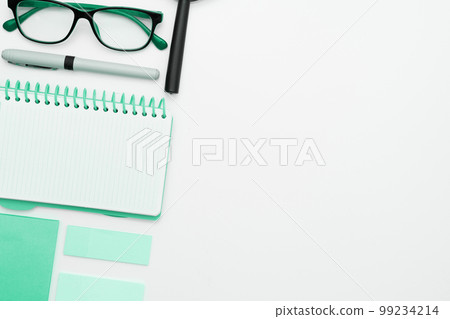 Office Supplies Over Desk With Keyboard And Glasses And Coffee Cup For Working Remotely, Assorted School Utilities For Studying With Hot Drink And Eyeglasses. Office Supplies Over Desk With Keyboard And Glasses And Coffee Cup For Working Remotely, Assorted School Utilities For Studying With Hot Drink And Eyeglasses. 99234214