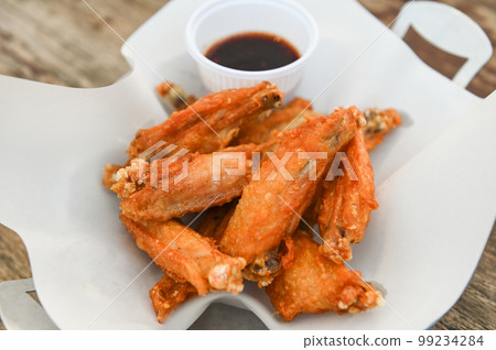 fried chicken wings with sauce thai food on wooden table food background fried chicken wings with sauce thai food on wooden table food background 99234284