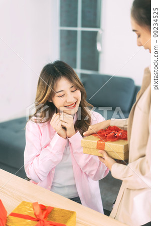 Young adult woman couple give for anniversary or holidays event 99234525