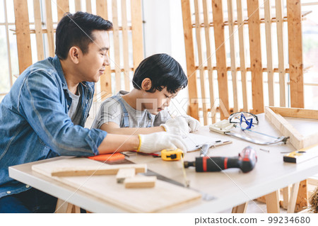 Southeast asian family father and son diy or repair for crafts skill at home workshop 99234680