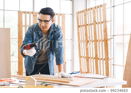 Middle age adult man carpenter job at home workshop Middle age adult man carpenter job at home workshop 99234683
