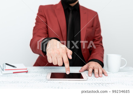 Businessman in Red jacket sitting at table And Pointing With One Finger On Important Message on the mobile phone. Gentleman Showing Critical Announcement. Businessman in Red jacket sitting at table And Pointing With One Finger On Important Message on the mobile phone. Gentleman Showing Critical Announcement. 99234685