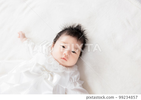 2 month old baby in baby dress 99234857