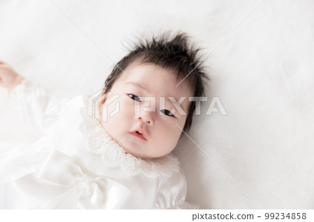 2 month old baby in baby dress 99234858