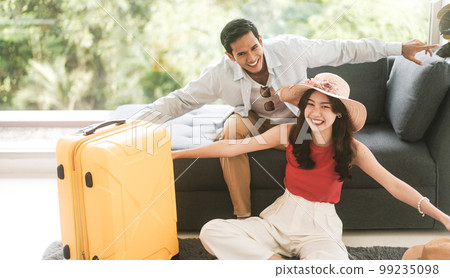 Asian couple man and woman smiling together enjoy departure fly pose for vacation travel 99235098