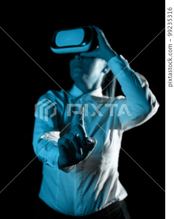Woman Wearing Vr Glasses And Pointing On Important Messages With One Finger. Businesswoman Having Virtual Reality Eyeglasses And Showing Crutial Informations. 99235316