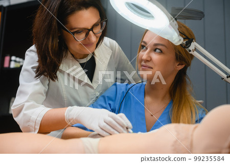 Beautician teach intern electrolysis in spa salon Beautician teach intern electrolysis in spa salon 99235584