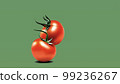 Multiple tomatoes with a green background 99236267