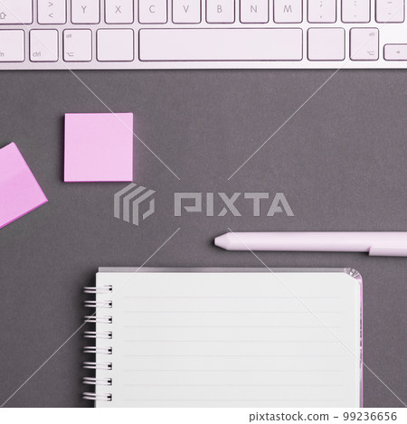 Colored paper with important message lying desk near keyboard. Main information written on notebook. School supplies. Multiple Assorted Collection Office Stationery. Colored paper with important message lying desk near keyboard. Main information written on notebook. School supplies. Multiple Assorted Collection Office Stationery. 99236656