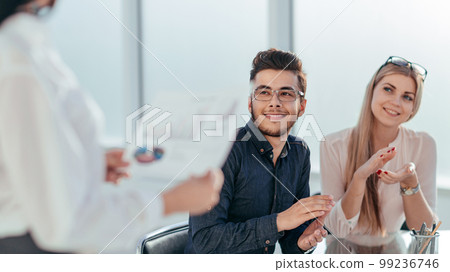 employees applauded at a business meeting in the office. employees applauded at a business meeting in the office. 99236746