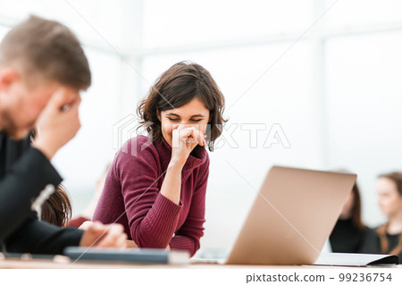 young people discussing something sitting at the table 99236754