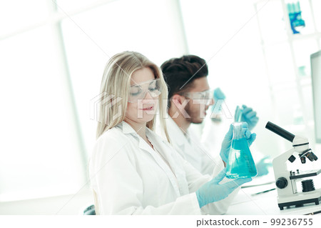 close up.young scientists are experimenting with liquid 99236755