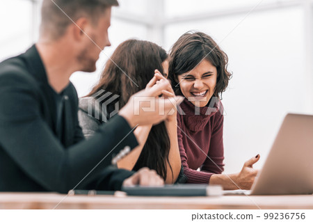 group of friends discussing online news sitting at a table 99236756