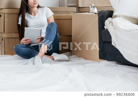 young woman making online purchases for her new apartment young woman making online purchases for her new apartment 99236806