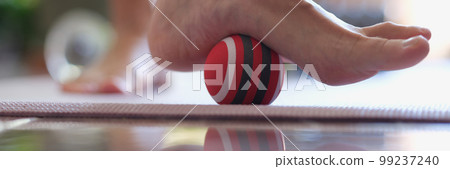 Female heel massage with massage tool for myofascial therapy closeup 99237240