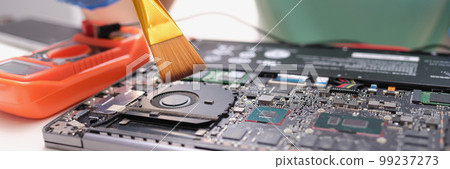 Maintenance laptop engineer holding dust brush closeup 99237273