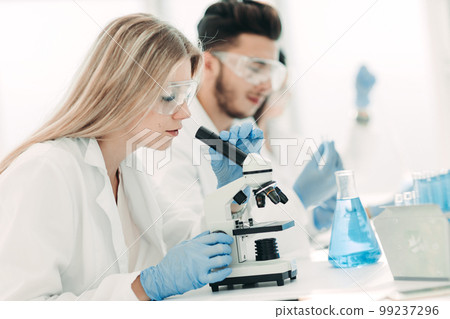 close up.woman scientist conducting experiments with liquid close up.woman scientist conducting experiments with liquid 99237296