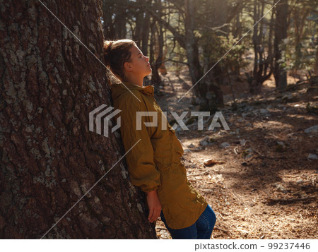 caucasian woman enjoys being in nature, 99237446