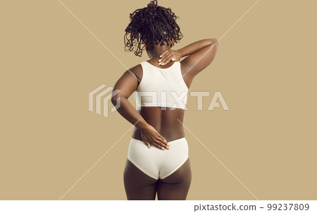 African woman with spine problems suffering from pain in neck and lower back areas 99237809