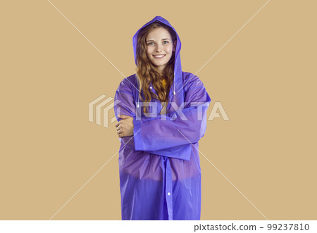 Portrait of smiling girl dressed in purple raincoat Portrait of smiling girl dressed in purple raincoat 99237810