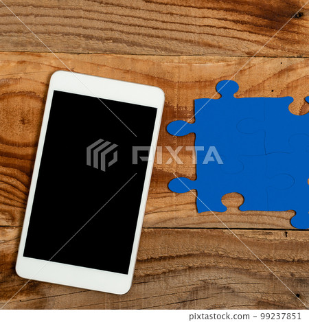 Mobile Phone With Important Message On Desk With Empty Dark Blue Puzzels And Notes. Cellphone Screen With Crutial Informations On Table With Notepad And Memos. Mobile Phone With Important Message On Desk With Empty Dark Blue Puzzels And Notes. Cellphone Screen With Crutial Informations On Table With Notepad And Memos. 99237851