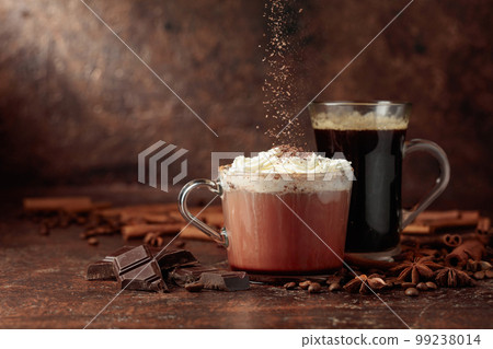 Hot chocolate with whipped cream and black coffee. Hot chocolate with whipped cream and black coffee. 99238014