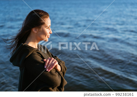 Portrait happy smiling woman on beach. Smiling sensual brunette posing 99238161