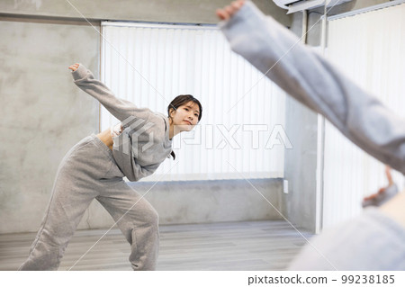 Young woman dancing while looking at the mirror in the dance studio Dance hip hop image 99238185