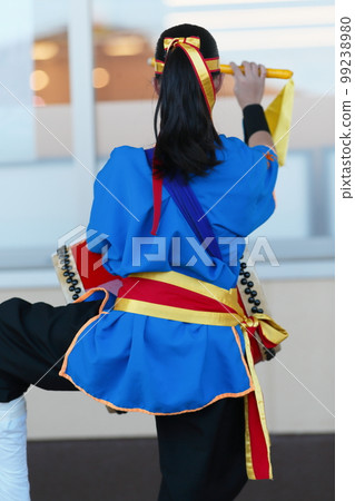 A woman's back during an Okinawa Eisa dance performance A woman's back during an Okinawa Eisa dance performance 99238980