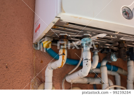 Rusty pipe on a gas boiler close-up. 99239284