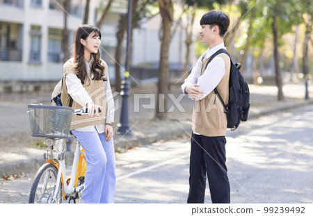 Happy students discussing in the park Happy students discussing in the park 99239492