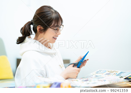 woman making a scrapbook woman making a scrapbook 99241359