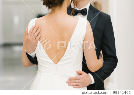 The groom hugs the bride by the shoulders. Close-up of hands 99241465