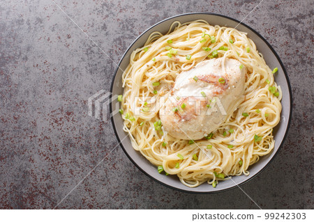 Angel chicken with cream cheese sauce, broth and herbs close-up in a bowl. Horizontal top view Angel chicken with cream cheese sauce, broth and herbs close-up in a bowl. Horizontal top view 99242303