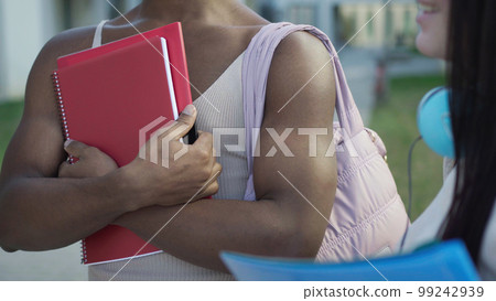 Faceless trendy transgender black man with notebook in hands Faceless trendy transgender black man with notebook in hands 99242939