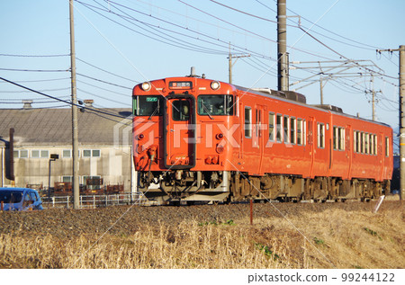 A vermilion local train running along the Nakaumi line in the evening A vermilion local train running along the Nakaumi line in the evening 99244122