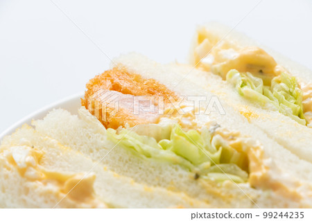 Shrimp cutlet sandwich close-up. (white background) Shrimp cutlet sandwich close-up. (white background) 99244235