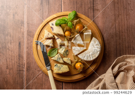 Cheese board with blue cheese, cheddar and fruit cheese. Wooden background, copy space 99244629