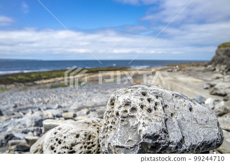 Stones with holes at storm beach by Carrowhubbuck North Carrownedin close to Inishcrone, Enniscrone in County Sligo, Ireland. Stones with holes at storm beach by Carrowhubbuck North Carrownedin close to Inishcrone, Enniscrone in County Sligo, Ireland. 99244710