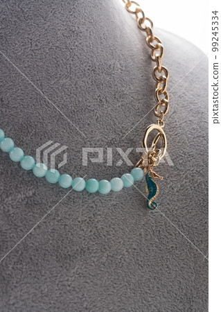 author necklace with azure gemstones and chain demonstrated on maneken. close up. fashion and jewelry concept author necklace with azure gemstones and chain demonstrated on maneken. close up. fashion and jewelry concept 99245334