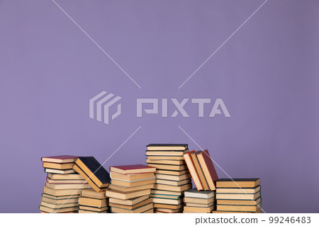 many books stacks on a purple background in the library science college university training 99246483