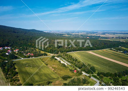 Mountain village, aerial view. Beautiful mountain landscape with residential neighborhood and green fields. Countryside view 99246543