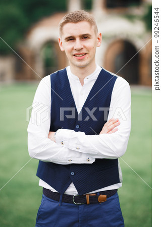 Headshot portrait of young man smiling isolated on outside outdoors background 99246544
