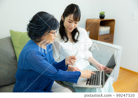A senior woman and a young woman in the living room A senior woman and a young woman in the living room 99247320