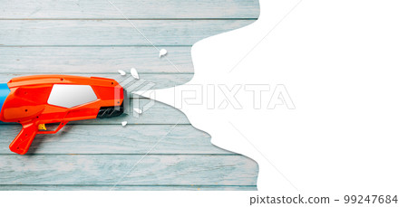 Happy songkran day festival at Thailand. water gun shoot water splash drawing empty space for text isolated on blue wooden background, traditional Thai New Year, Web banner design 99247684