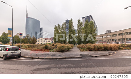 Panorama showing skyscrapers and towers from park with green lawn timelapse in Milan Panorama showing skyscrapers and towers from park with green lawn timelapse in Milan 99247805