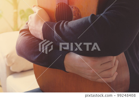Classical acoustic guitar and hands of a musician close-up. Musical concept 99248408