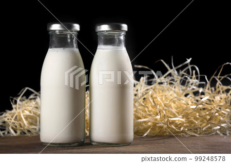 Two bottles of fresh milk on a black background. Healthy food Two bottles of fresh milk on a black background. Healthy food 99248578