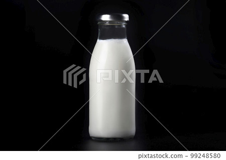 Bottles of milk isolated on a black background. Dairy food 99248580